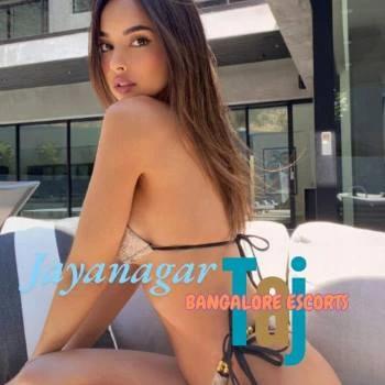 In this photo an American model is sitting and putting the logo of Call Girl in Jayanagar